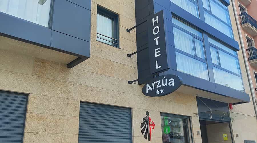 Hotel Arzúa sign on modern building facade with stone cladding and large windows