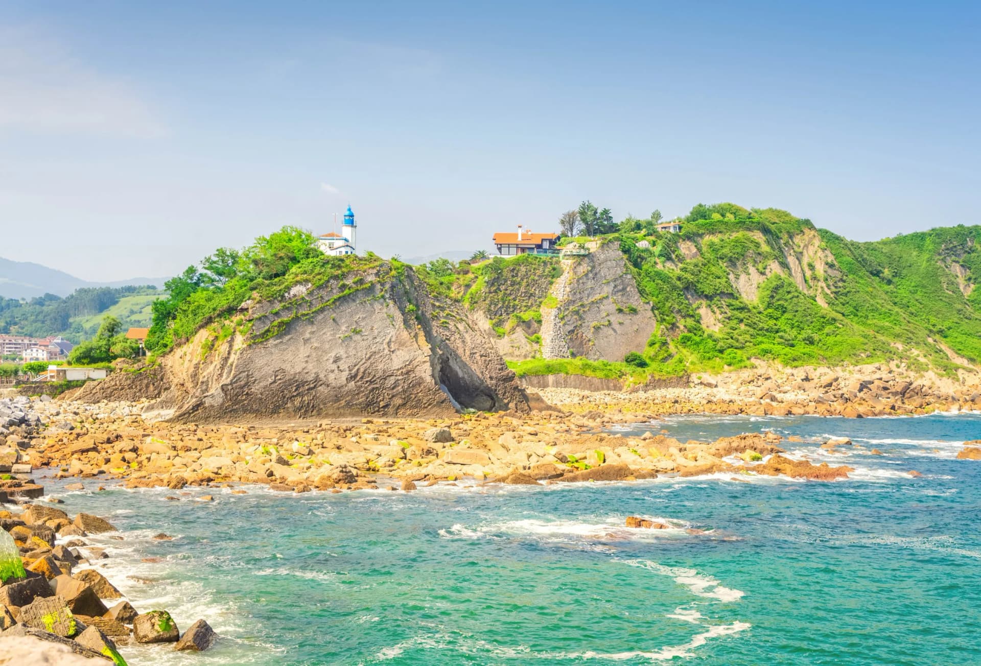 light house at rocks of Zumaia coast, Pais Vasco Spain, toned