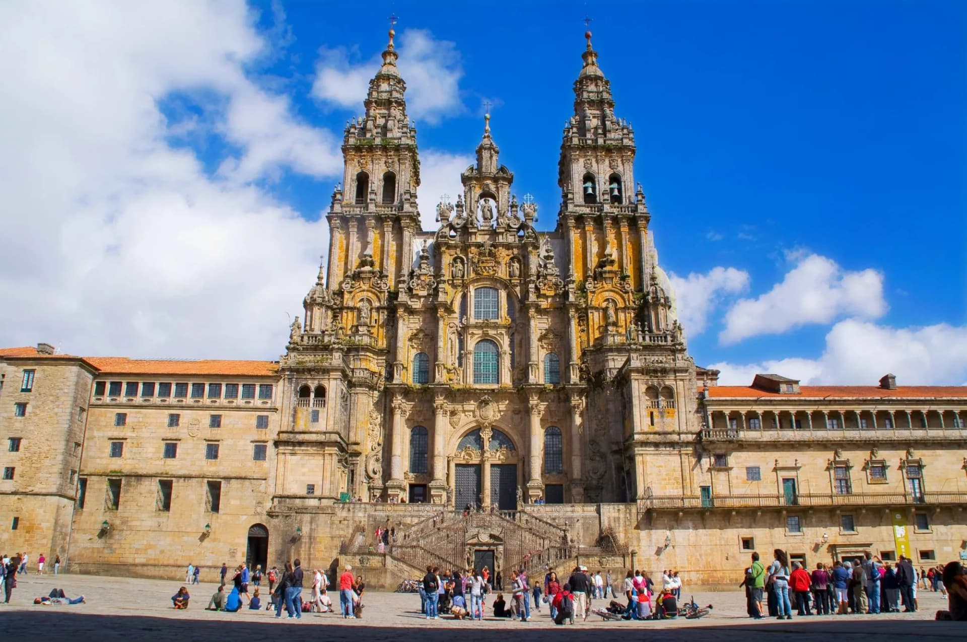 Cathedral of Santiago de Compostela facade with ornate towers and crowds in the plaza.