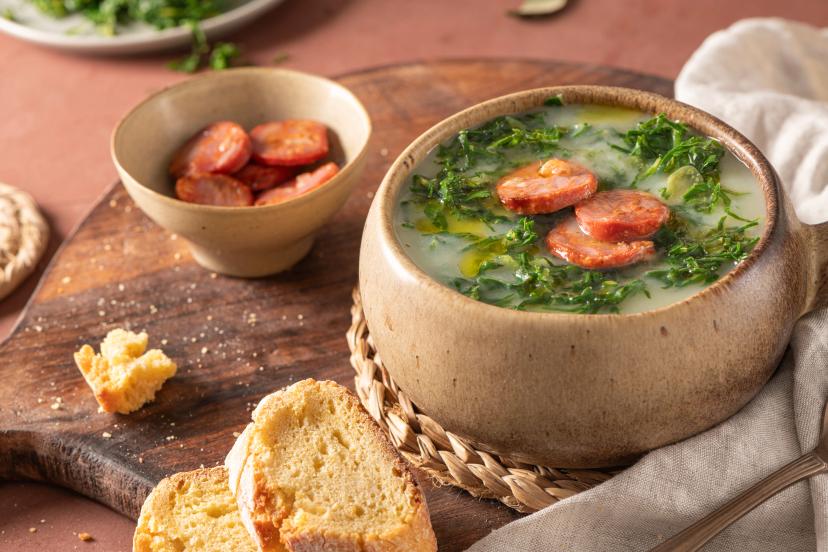 Caldo verde popular soup in Portuguese cuisine. Traditional ingredients for caldo verde are potatoes, onion, garlic, collard greens, chorizo , olive oil and salt.