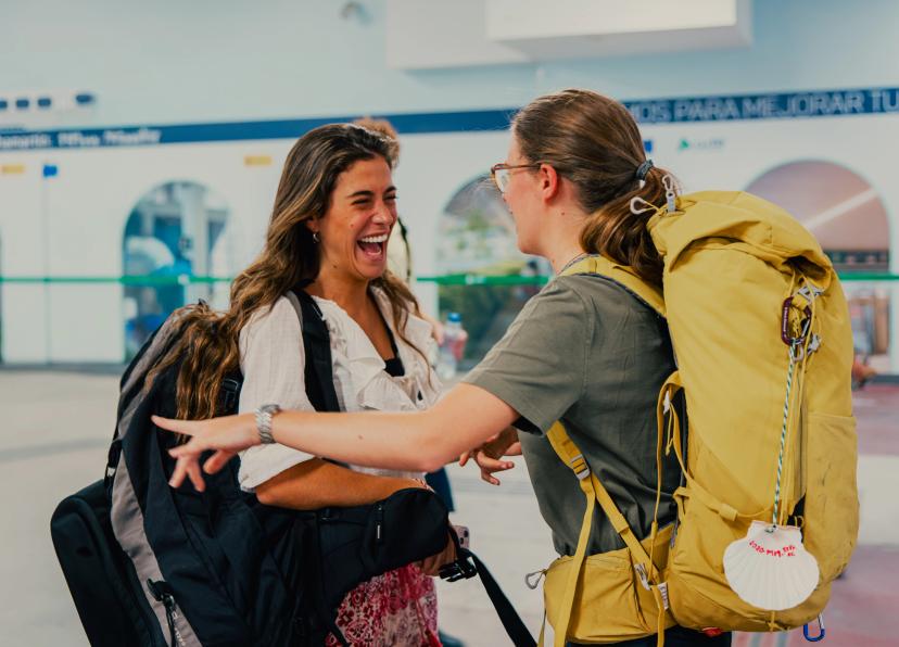 Pilgrims embracing with joy after long journey on Camino de Santiago