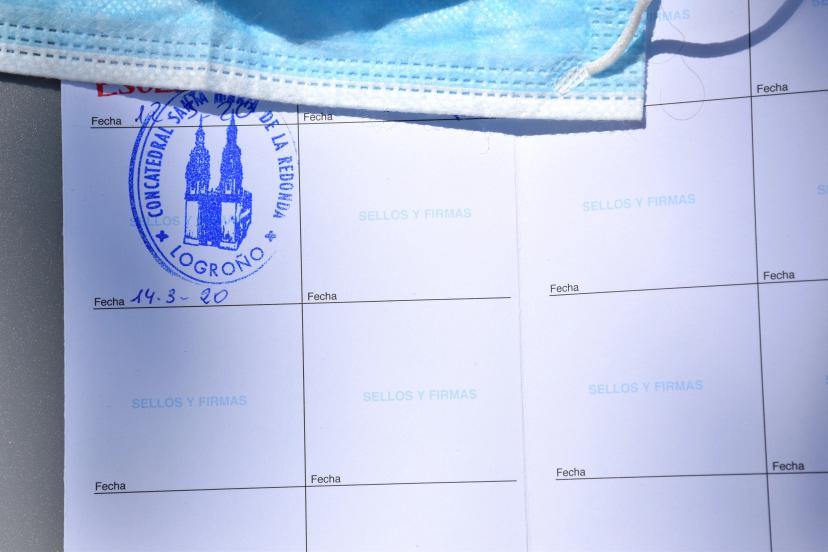Piece of mask and sheet to seal the stages of the Camino de Santiago, last seal of the Co-cathedral of Logroño, March 14, 2020, the day the state of alarm for coronavirus was declared in Spain.