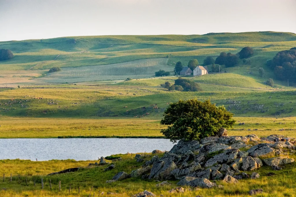 Farm, lake and meadows: a landscape of the Aubrac plateau in France