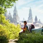 Tourist Woman On Pilgrimage At Santiago De Compostela With Phone